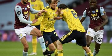 Aston Villa's Conor Hourihane (left) battles for the ball with Arsenal's David Luiz (centre) and Dani Ceballos during the Premier League match at Villa Park, Birmingham.